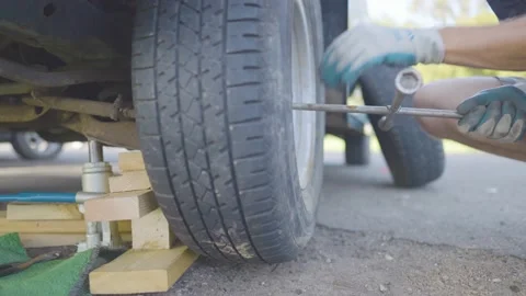 Man Changes Tire - Slow Motion Stock Footage 178485418