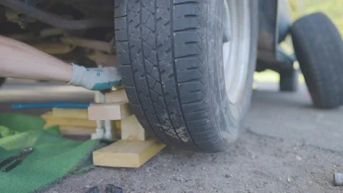 Man Changes Tire - Slow Motion Stock Footage 178485611