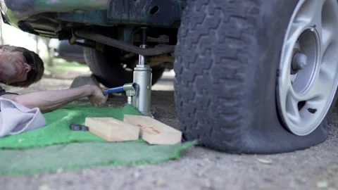 Man Changes Tire - Slow Motion Stock Footage 178487609