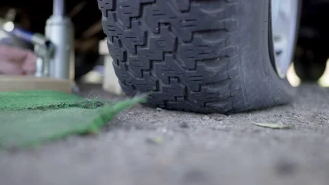 Man Changes Tire - Slow Motion Stock Footage 178488447