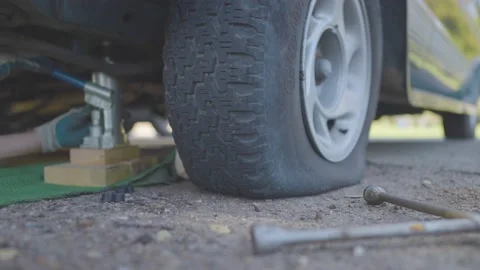 Man Changes Tire - Slow Motion Stock Footage 178488881