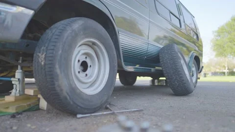 Man Changes Tire - Slow Motion Stock Footage 178490142
