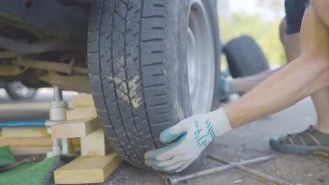 Man Changes Tire - Slow Motion Stock Footage 178490827