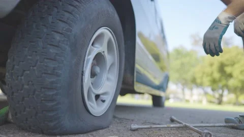 Man Changes Tire - Slow Motion Stock Footage 178492107