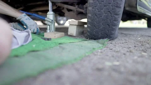 Man Changes Tire - Slow Motion Stock Footage 178492163