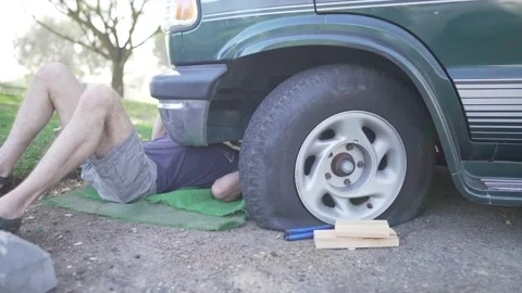 Man Changes Tire - Slow Motion Stock Footage 178492267