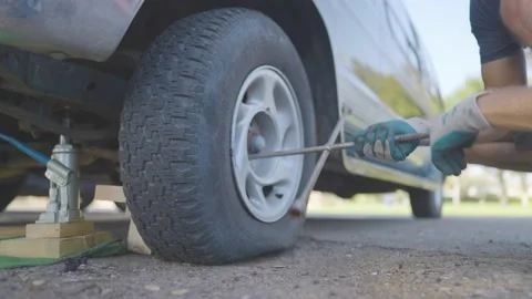 Man Changes Tire - Slow Motion Stock Footage 178492445