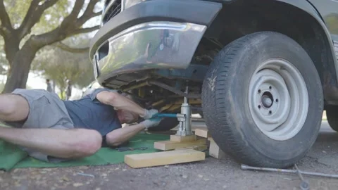 Man Changes Tire - Slow Motion Stock Footage 178504771