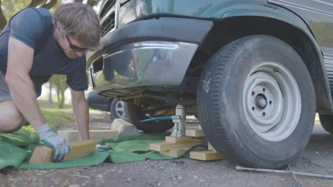 Man Changes Tire - Slow Motion Stock Footage 178505301