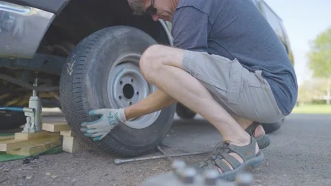 Man Changes Tire - Slow Motion Stock Footage 178505726