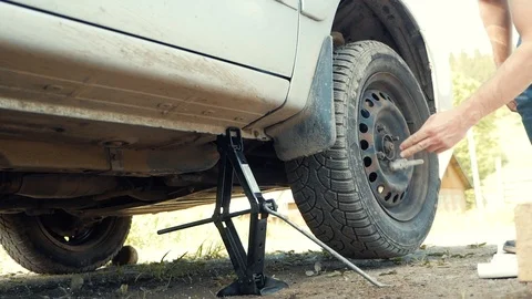 The man changes the wheel in the car Stock Footage 109061043