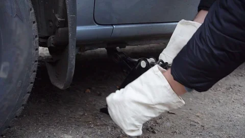Man changes the wheel on the car on the road Stock Footage 100366971