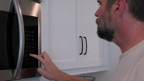 Man Changing Appliance Clock for Daylight Savings Stock Footage 340532615