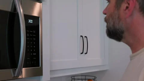 Man Changing Appliance Clock for Daylight Savings Stock Footage 340532617