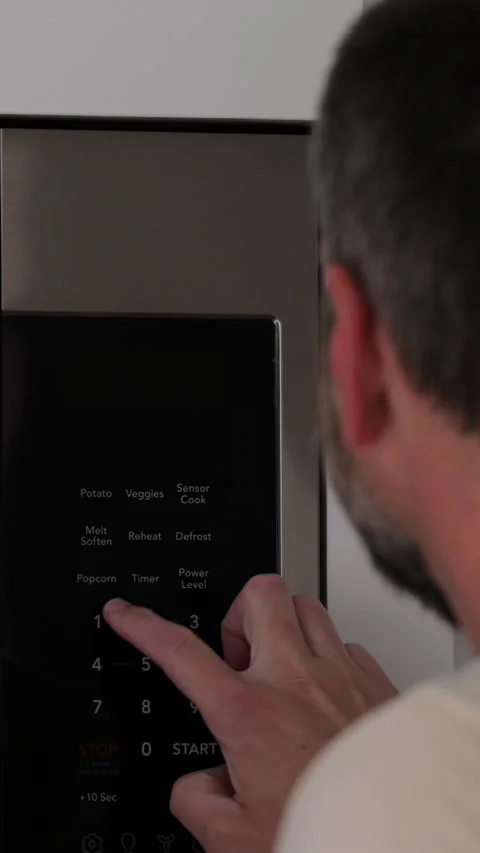 Man Changing Appliance Clock for Daylight Savings Stock Footage 340532623