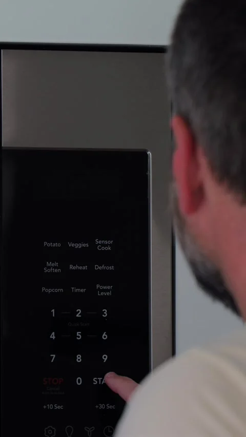 Man Changing Appliance Clock for Daylight Savings Stock Footage 340532625