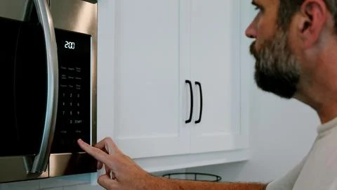 Man Changing Appliance Clock for Daylight Savings Stock Photos