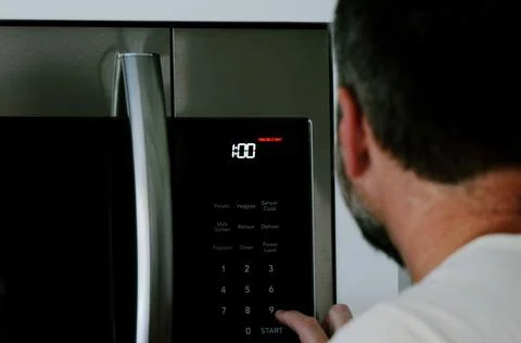 Man Changing Appliance Clock for Daylight Savings Stock Photos