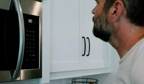 Man Changing Appliance Clock for Daylight Savings Stock Photos