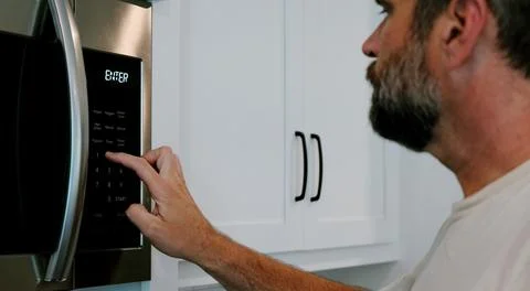 Man Changing Appliance Clock for Daylight Savings Stock Photos