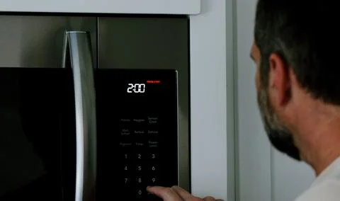 Man Changing Appliance Clock for Daylight Savings Stock Photos