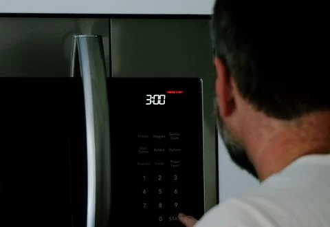 Man Changing Appliance Clock for Daylight Savings Stock Photos
