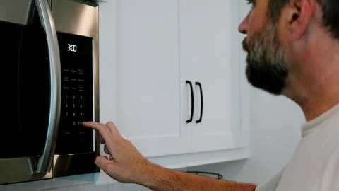 Man Changing Appliance Clock for Daylight Savings Stock Photos