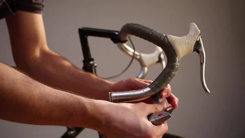 Man changing bar tape for road bike. Video stock 70409817