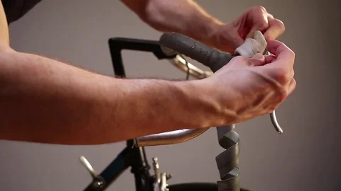 Man changing bar tape for road bike. Stock Footage 70409944