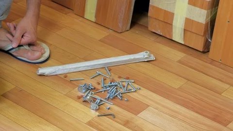 Man changing bolts and nuts desired size to collect furniture, hands closeup. Video stock 124856332