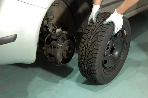 Man changing car tires Stock Photos