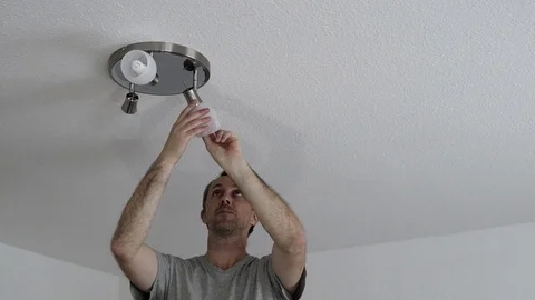 Man Changing Ceiling Fixture Light Bulb Stock Footage 73534136