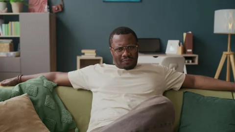 Man Changing Facial Expression from Tense to Satisfied while Watching TV Stock Footage 316919242