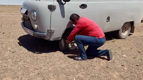 Man changing flat tire Stock Footage 343340225