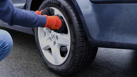 Man changing flat tire on his car after road accident Stock-Footage 111424840