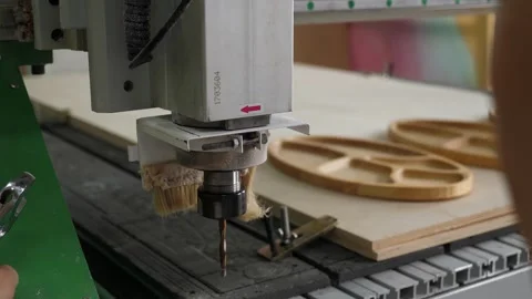 A man changing a nozzle with a drill on an industrial wood carving machine. Stock Footage 288333839