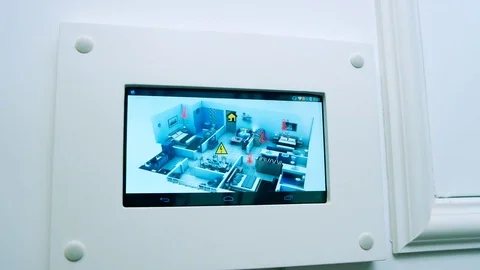 A man changing the temperature on a programmable thermostat on the house wall Stock Footage 74184488