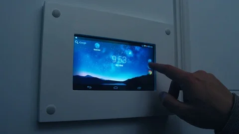 A man changing the temperature on a programmable thermostat on the house wall Video stock 74190685