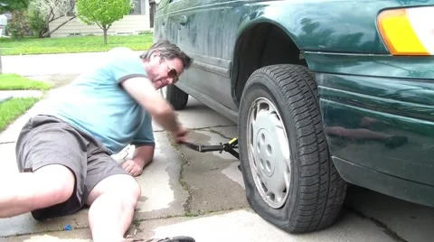 Man Changing Tire with Jack Video stock 65745613