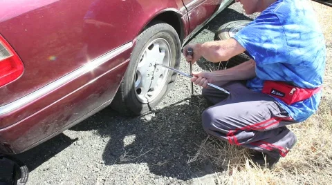 Man Changing Tire Sequence Stock Footage 862081