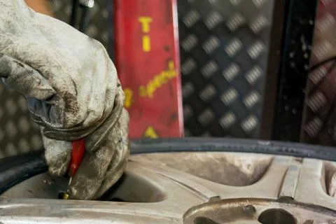 Man changing the tire valve Stock Photos
