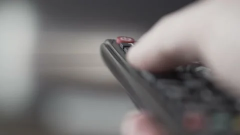 Man changing the volume and TV channels on remote Stock Footage 155287698