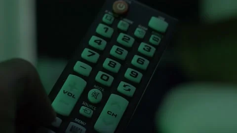 Man Changing the Volume on TV Remote Stock Footage 157942269