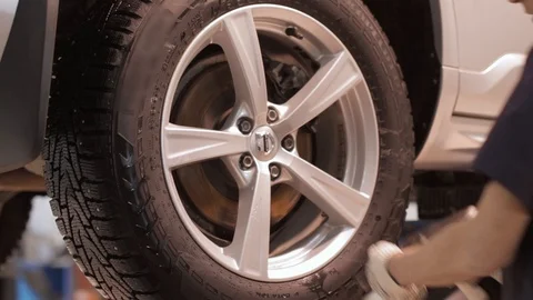 Man Changing Wheel on a Car Stock Footage 87954079