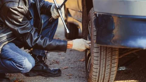 Man changing wheel on a car Stock Photos