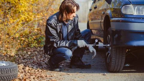 Man changing wheel on a car Stock Photos