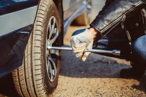 Man changing wheel on a car Stock Photos