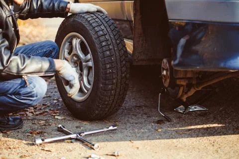 Man changing wheel on a car Stock Photos