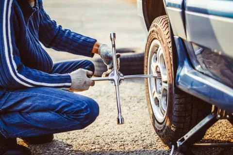 Man changing wheel on a car Stock Photos