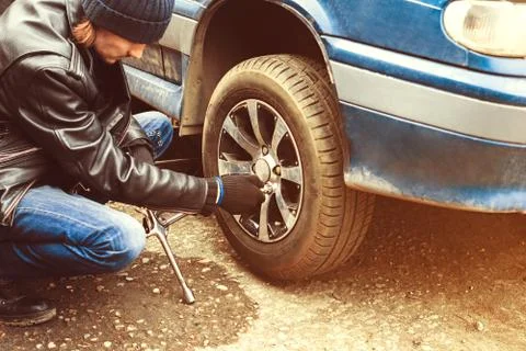 Man changing wheel on a car Stock Photos